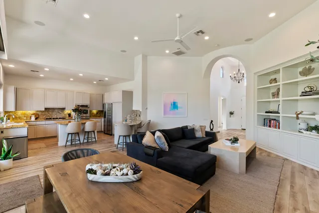 a living room with furniture kitchen view and a table
