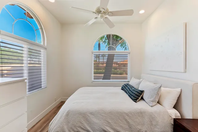 a view of a white house with a big yard and large trees