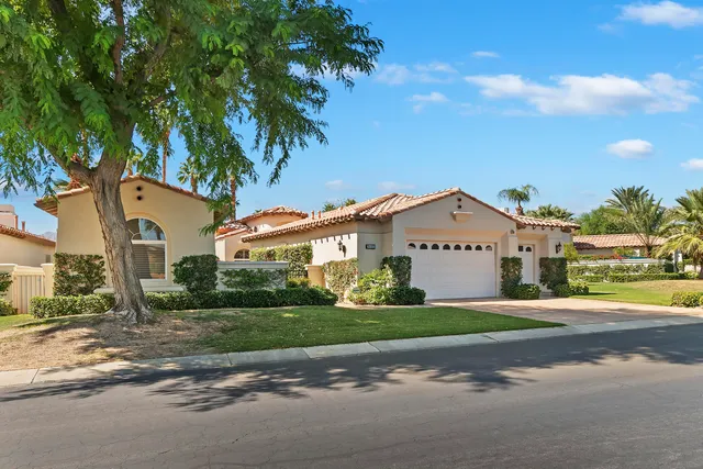 a view of swimming pool with a garden and plants