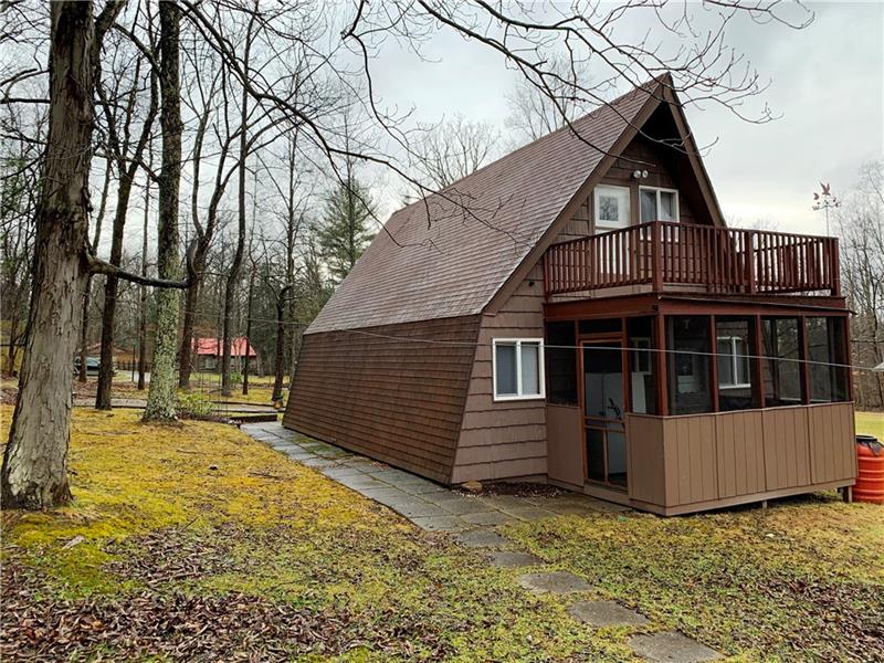 Back exterior offers a nice deck off the loft bedroom and screened porch.