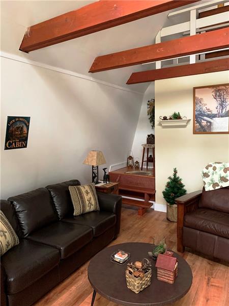 View of the open living area with stairs to loft.