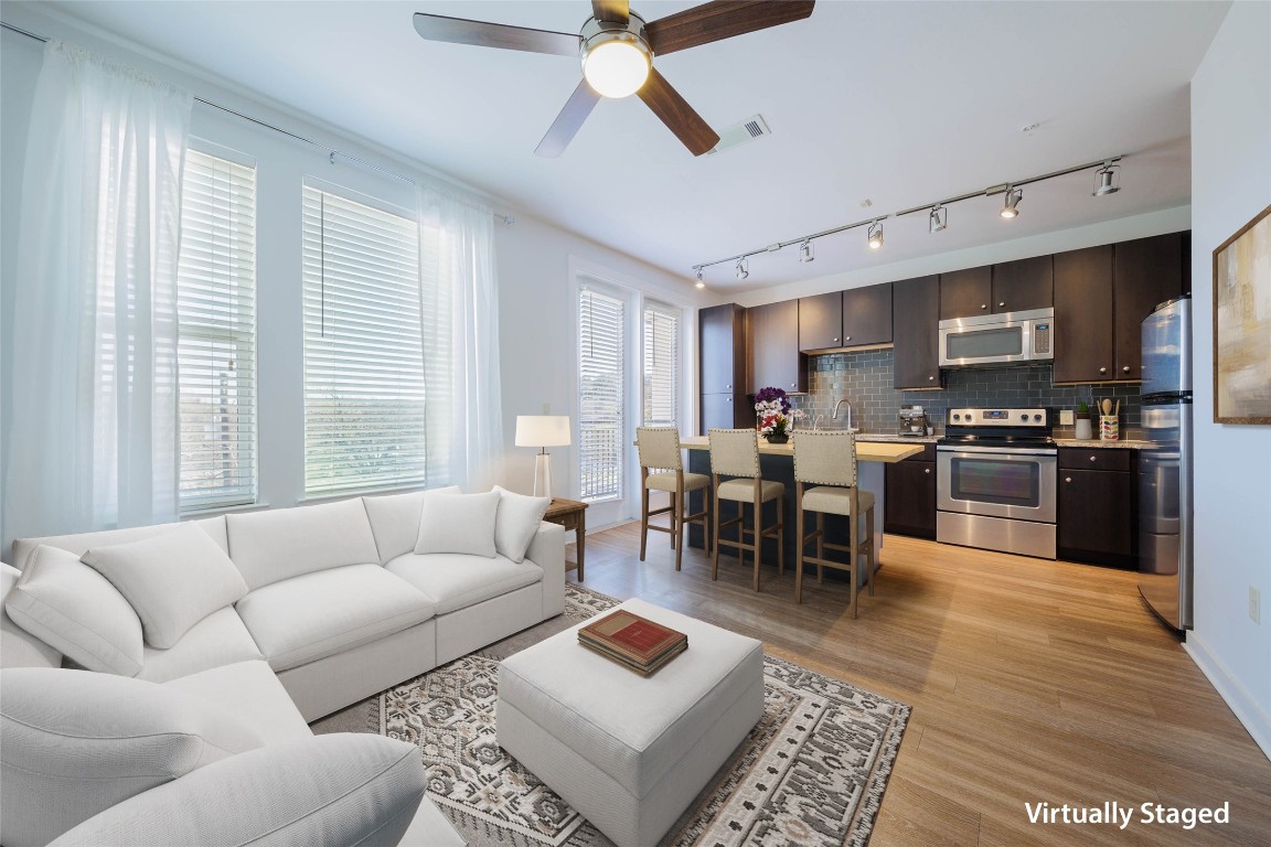 1900 Barton Springs Road, Unit 4002 Austin, TX 78704 - Photo 1 of 1 a living room with furniture wooden floor and a view of kitchen