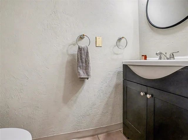 a bathroom with a sink mirror and toilet