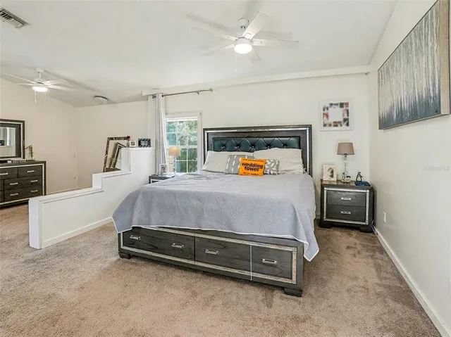 a bedroom with a bed and a tv