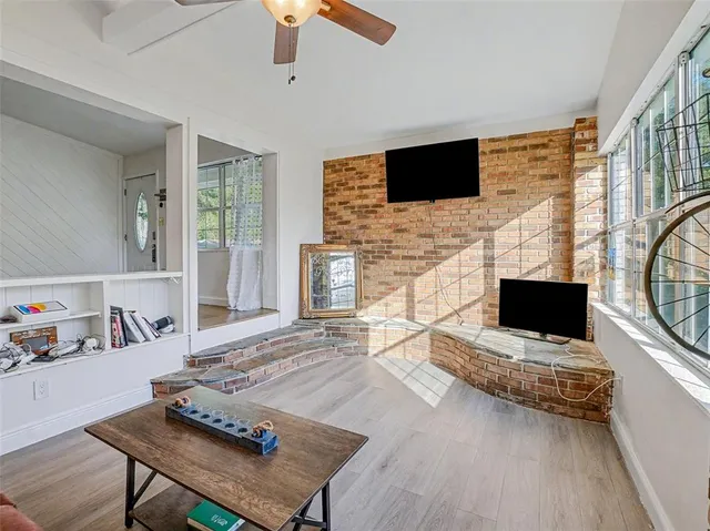 a living room with fireplace furniture and a flat screen tv