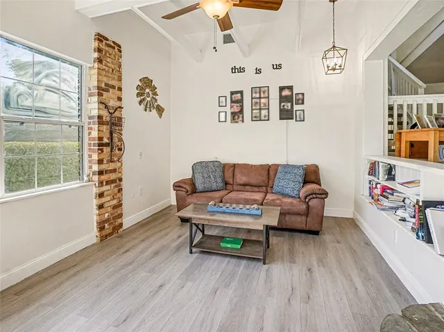 a living room with furniture and wooden floor