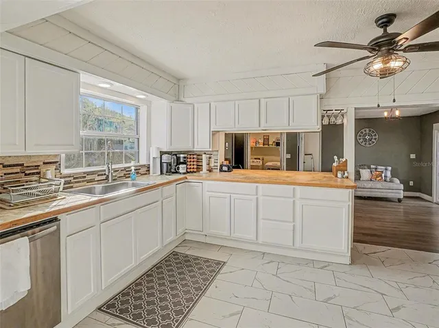 a kitchen with a sink cabinets and window