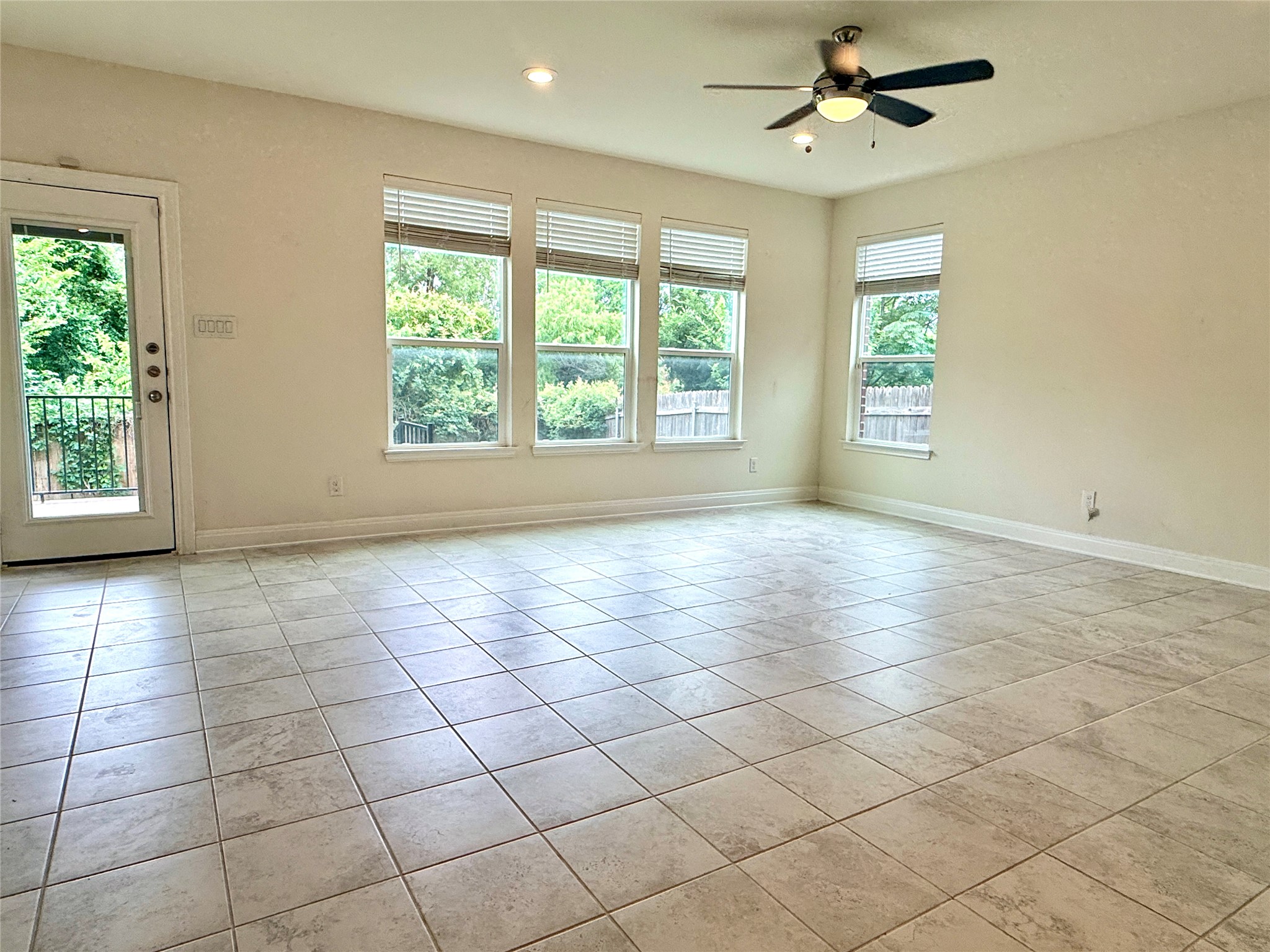 2101 Split Diamond Way, Unit 40 Round Rock, TX 78664 - Photo 11 of 32 Natural light floods this living area through multiple windows and a glass-paneled door.