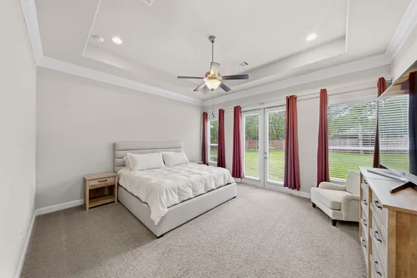 a bedroom with furniture and a flat screen tv