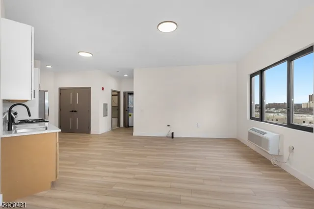 a view of a kitchen with a sink and a large window