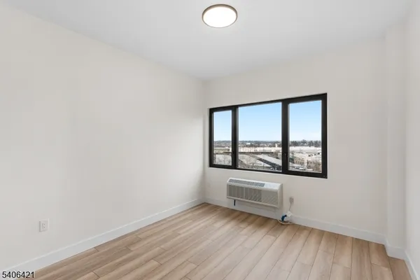 a view of a room with wooden floor and window