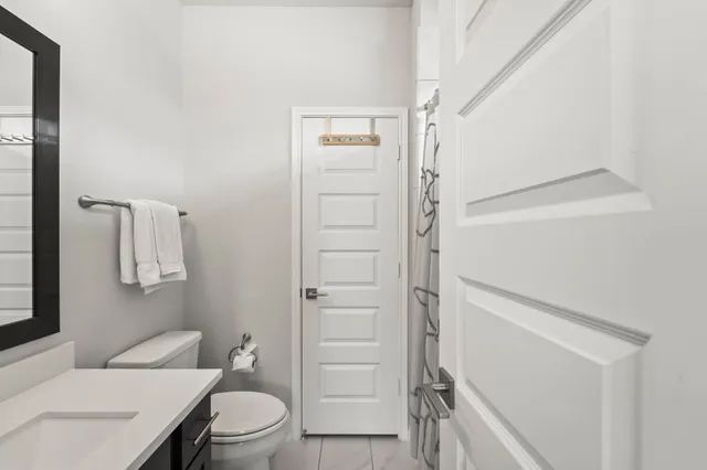 a bathroom with a sink toilet and mirror