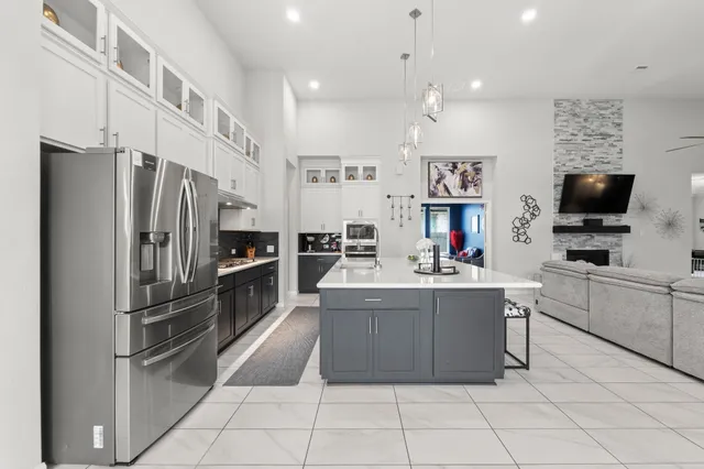 a kitchen with a sink a stove and cabinets