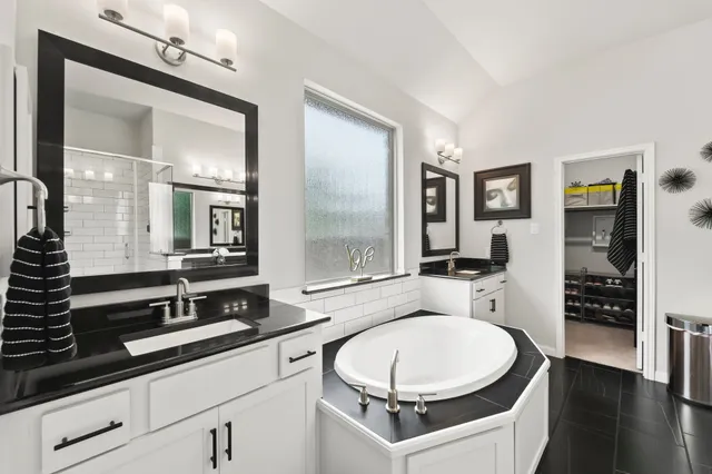 a backyard of a house with table chairs and a fire pit