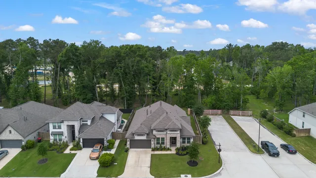 an aerial view of a house with swimming pool and garden