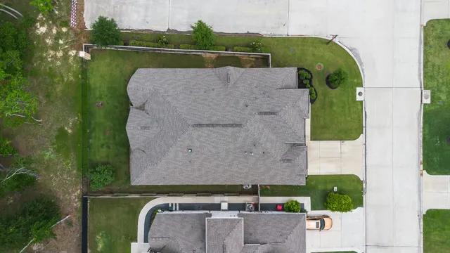 an aerial view of residential houses with outdoor space and street view