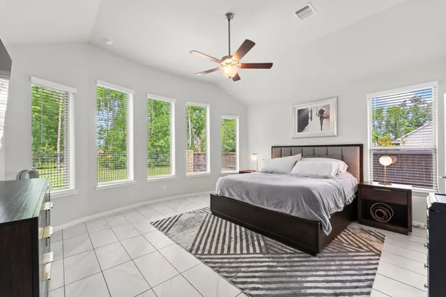 a bedroom with a large bed and a window