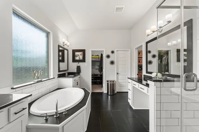 a large white kitchen with a large window