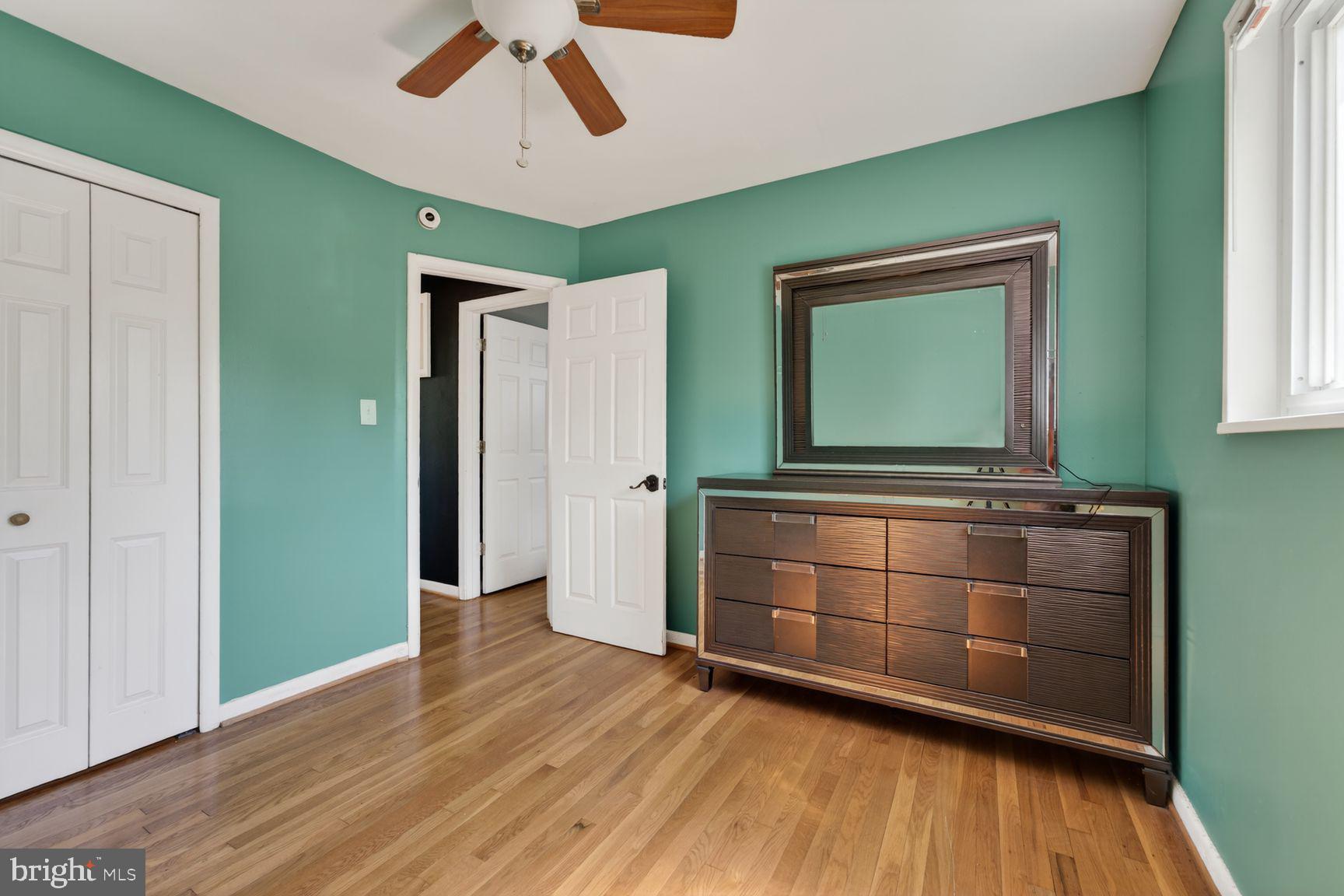 1104 Caddington Avenue Silver Spring, MD 20901 - Photo 15 of 35 a room with a mirror and a dresser