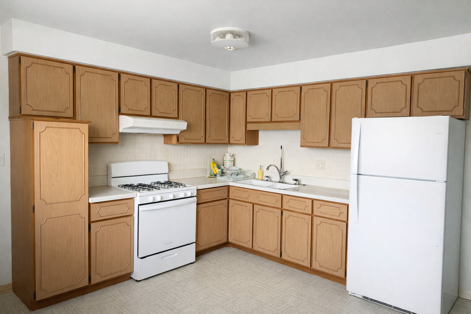 8304 W Forest, Unit 3W Chicago, IL 60634 - Photo 3 of 8 a kitchen with a sink a refrigerator and cabinets