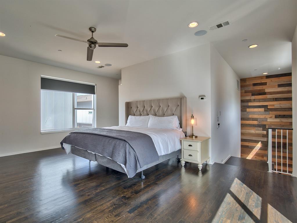 5205 Capitol Avenue, Unit 1 Dallas, TX 75206 - Photo 15 of 39 a spacious bedroom with a bed and wooden floor