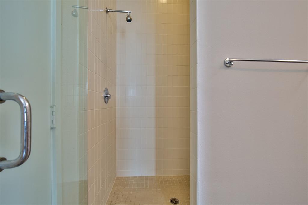 5205 Capitol Avenue, Unit 1 Dallas, TX 75206 - Photo 18 of 39 a bathroom with a glass shower door