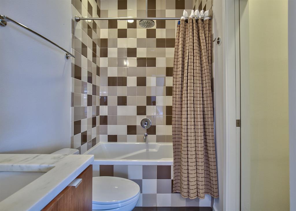 5205 Capitol Avenue, Unit 1 Dallas, TX 75206 - Photo 22 of 39 a bathroom with a sink toilet and shower