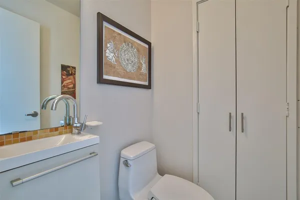 a bathroom with a toilet a sink and mirror