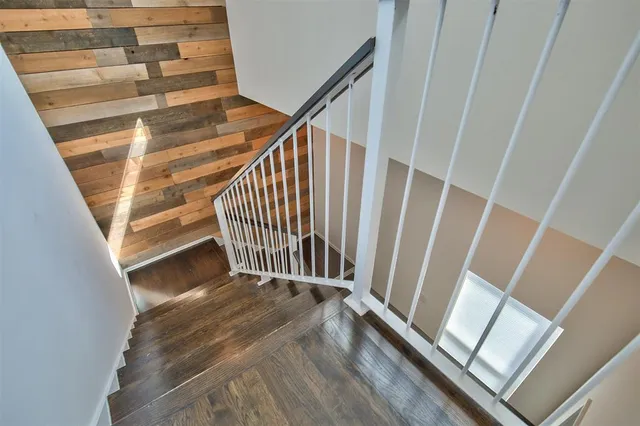 a view of staircase with white walls and a window