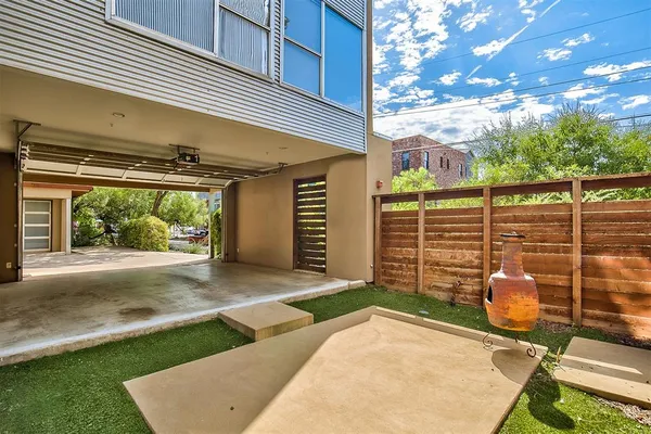 a backyard of a house with garden and outdoor seating