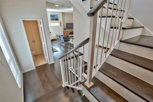 a view of staircase with white walls and a window