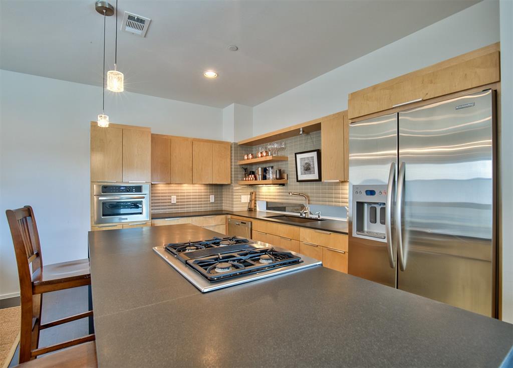 5205 Capitol Avenue, Unit 1 Dallas, TX 75206 - Photo 9 of 39 a kitchen with stainless steel appliances granite countertop a stove and a refrigerator