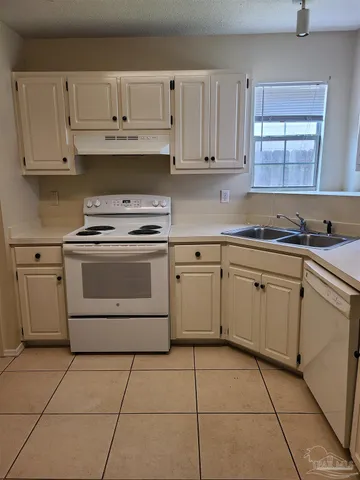 a kitchen with cabinets appliances and a sink