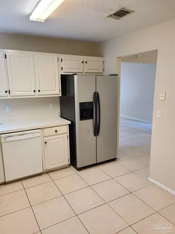 a utility room with cabinets washer and dryer