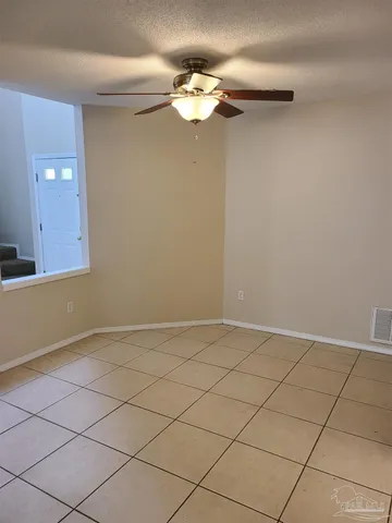 a view of a chandelier fan and wooden floor
