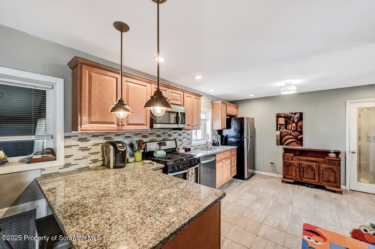 3618 Winfield Avenue Moosic, PA 18507 - Photo 13 of 54 a kitchen with kitchen island granite countertop a sink counter top space appliances and cabinets