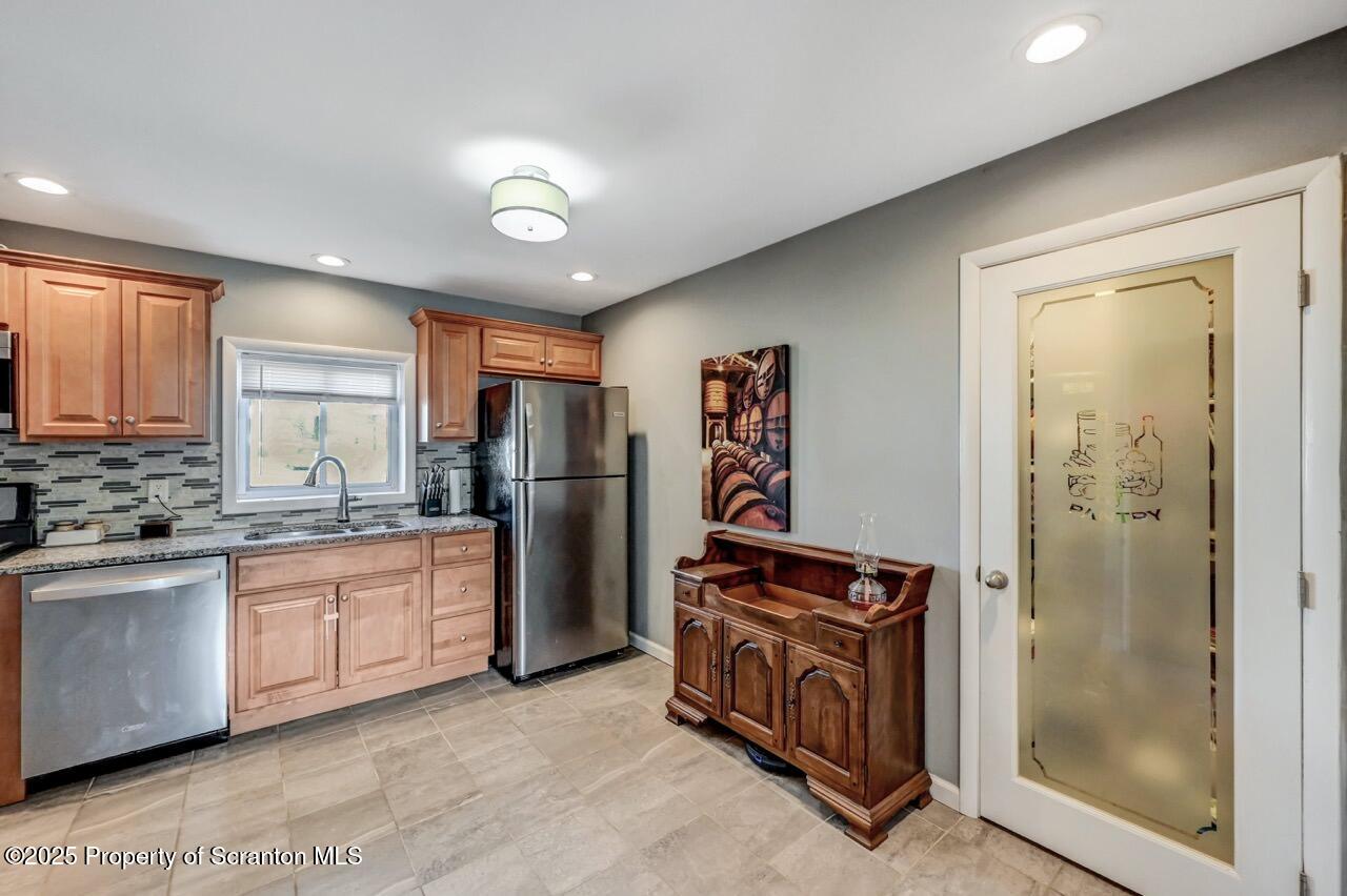 3618 Winfield Avenue Moosic, PA 18507 - Photo 20 of 54 a kitchen with stainless steel appliances granite countertop a refrigerator and a sink