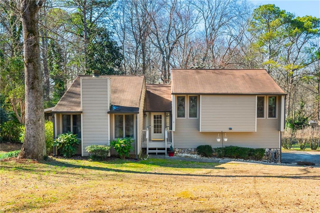 115 Creekview Drive Woodstock, GA 30188 - Photo 1 of 1 a front view of a house with a garden and tree