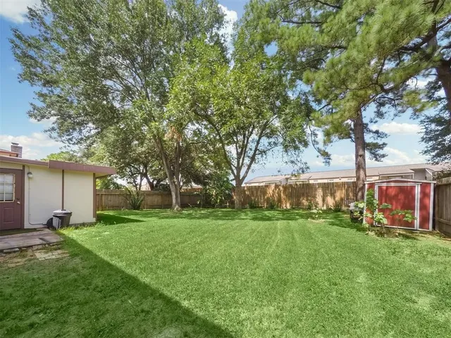 a backyard of a house with lots of green space and fountain