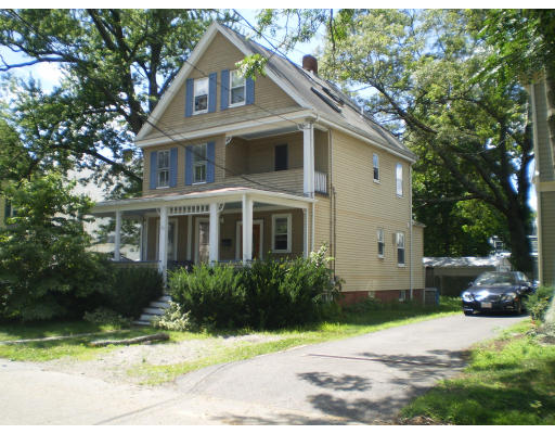 a house that has a tree in front of it