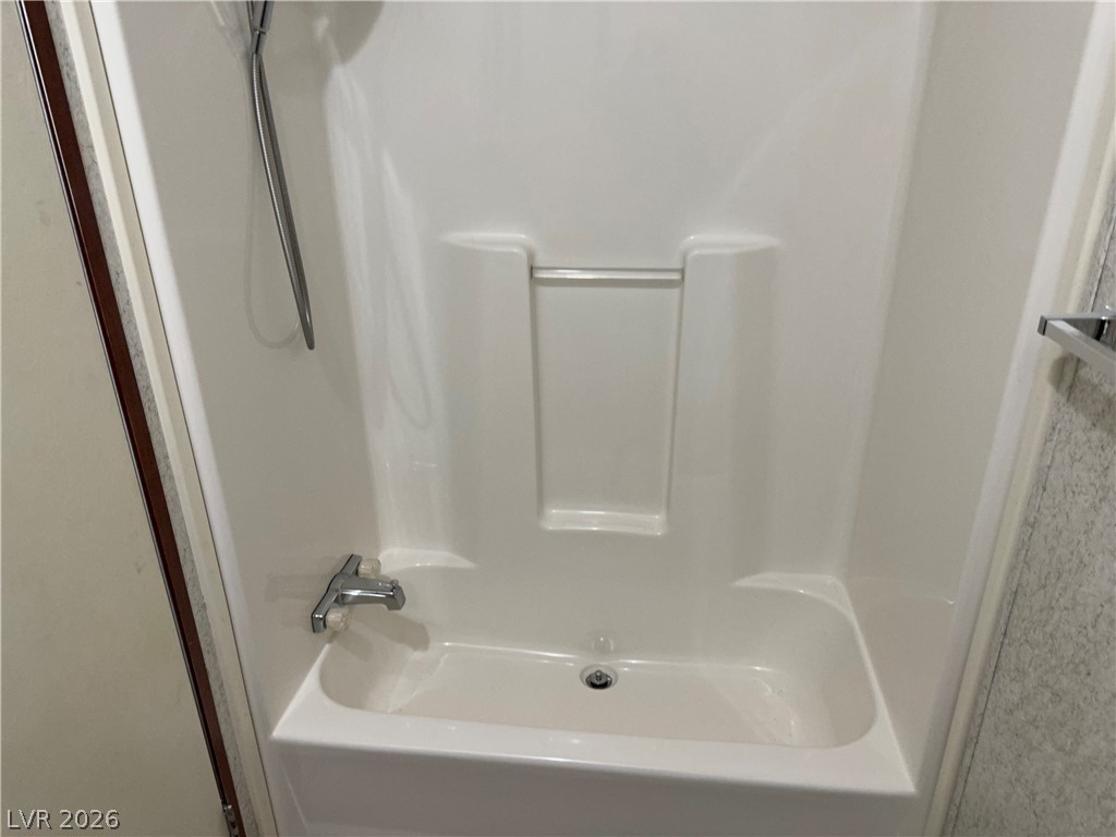 3270 West Simkins Road Pahrump, NV 89060 - Photo 22 of 36 A functional shower and tub combination provides practical convenience within the home.