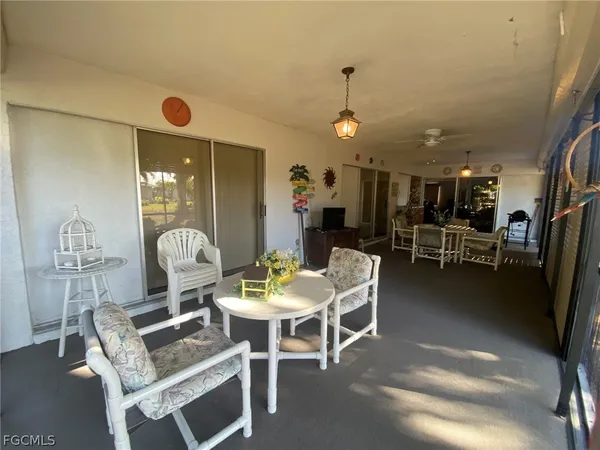a view of a dining room with furniture and a chandelier