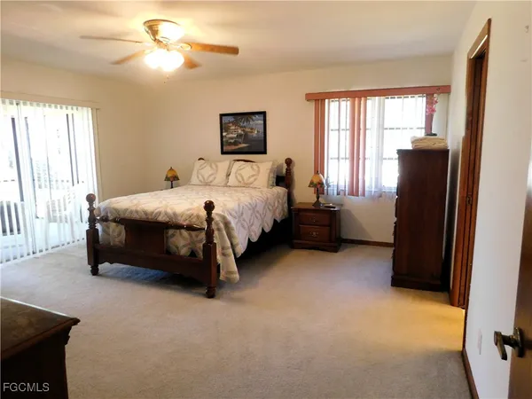 a spacious bedroom with a bed and a chandelier