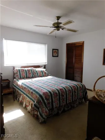 a bedroom with a bed and ceiling fan