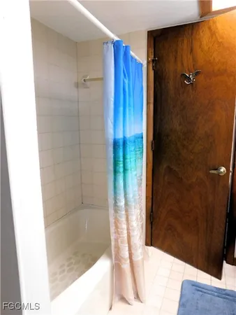 a bathroom with a bathtub and shower