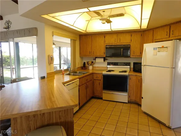 a kitchen with a sink appliances and cabinets
