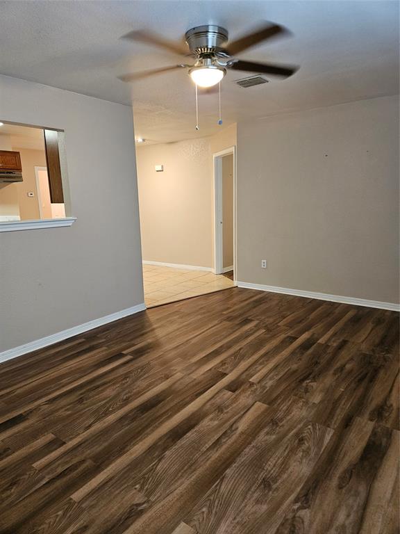 225 East Craven Avenue Lacy-Lakeview, TX 76705 - Photo 2 of 11 a view of an empty room with a chandelier fan
