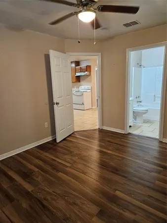 a view of empty room with wooden floor