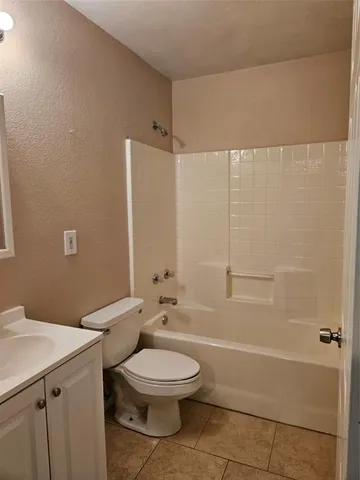 a bathroom with a toilet a sink and shower