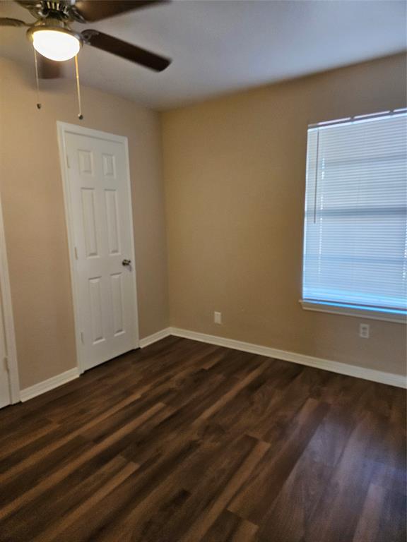 225 East Craven Avenue Lacy-Lakeview, TX 76705 - Photo 10 of 11 a view of an empty room with wooden floor and a window